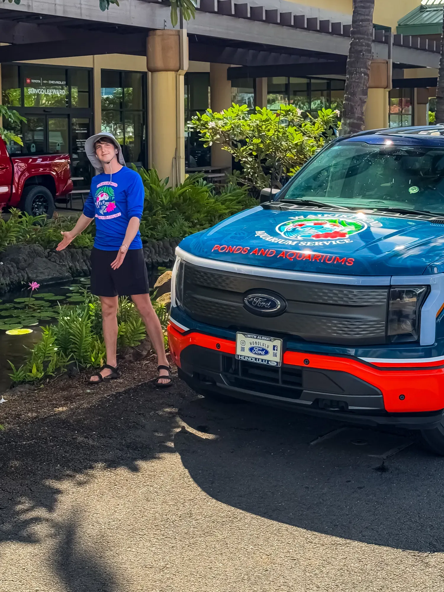 The wrapped truck parked beside a lily pond.